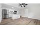 Open-concept kitchen with stainless steel appliances and modern fixtures and hardwood flooring at 7635 Pier Rd, Port Richey, FL 34668
