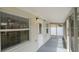 Enclosed patio with a security camera, door, large window, and painted concrete floor at 7635 Pier Rd, Port Richey, FL 34668
