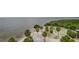 Picturesque view from the shore with tropical palm trees along a beach at 7635 Pier Rd, Port Richey, FL 34668