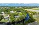 Gorgeous aerial view of home with private dock and waterway access surrounded by mature trees and lush landscaping at 5700 Oakview Ln, Punta Gorda, FL 33950