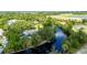 Beautiful aerial view of home on waterway showing private dock surrounded by mature trees and lush landscaping at 5700 Oakview Ln, Punta Gorda, FL 33950
