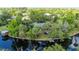 Charming aerial view of home with a private dock on the waterway, enveloped by mature trees and lush landscaping at 5700 Oakview Ln, Punta Gorda, FL 33950