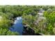 Picturesque aerial view of home with a private dock along the waterway with mature trees and lush landscaping at 5700 Oakview Ln, Punta Gorda, FL 33950