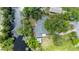 Stunning aerial view of the property's boundaries, showcasing lush landscaping, mature trees, and waterway access at 5700 Oakview Ln, Punta Gorda, FL 33950