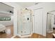 Bathroom featuring a glass shower, tiled floors, and a view into the bedroom, perfect for relaxation at 5700 Oakview Ln, Punta Gorda, FL 33950