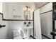Classic bathroom featuring black and white tile, pedestal sink, and shower with curtain at 5700 Oakview Ln, Punta Gorda, FL 33950
