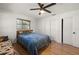 This bedroom boasts hardwood floors, a ceiling fan, and a closet for added storage space at 5700 Oakview Ln, Punta Gorda, FL 33950