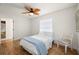 Bright bedroom featuring wood-look floors, ceiling fan, and a window providing natural light at 5700 Oakview Ln, Punta Gorda, FL 33950