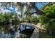 A dock on the water featuring lush, mature trees hanging above at 5700 Oakview Ln, Punta Gorda, FL 33950