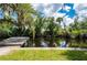 A dock on the water featuring lush, mature trees hanging above at 5700 Oakview Ln, Punta Gorda, FL 33950