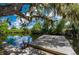 A dock on the water featuring lush, mature trees hanging above at 5700 Oakview Ln, Punta Gorda, FL 33950