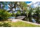 A dock on the water featuring lush, mature trees hanging above at 5700 Oakview Ln, Punta Gorda, FL 33950