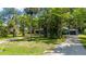 Front exterior view of the home from the driveway, with mature landscaping at 5700 Oakview Ln, Punta Gorda, FL 33950