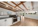 Bright open kitchen featuring a vaulted ceiling with wooden beams, granite countertops, and stainless steel appliances at 5700 Oakview Ln, Punta Gorda, FL 33950