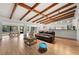 Bright and open living room with beamed ceilings, seamlessly connecting to the kitchen and dining areas at 5700 Oakview Ln, Punta Gorda, FL 33950