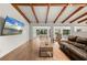 Relaxing living room with a large TV and beams at 5700 Oakview Ln, Punta Gorda, FL 33950