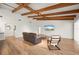 Spacious living room with beamed ceilings, and large TV at 5700 Oakview Ln, Punta Gorda, FL 33950