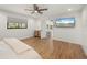 Comfortable main bedroom with hardwood floors, a ceiling fan, and an ensuite bathroom with modern fixtures at 5700 Oakview Ln, Punta Gorda, FL 33950