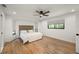 Serene bedroom featuring a plush bed, hardwood floors, and large windows providing natural light at 5700 Oakview Ln, Punta Gorda, FL 33950