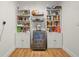 Organized pantry featuring white shelving units, cabinets, wood countertops, and a beverage cooler at 5700 Oakview Ln, Punta Gorda, FL 33950