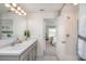 Well-lit bathroom with double sink vanity and walk-in shower at 14037 Canada Goose Rd, Brooksville, FL 34614