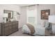 Comfortable bedroom with dresser and window offering natural light at 14037 Canada Goose Rd, Brooksville, FL 34614