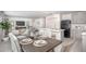 Open-concept dining area adjacent to a modern kitchen and living room, perfect for entertaining at 14037 Canada Goose Rd, Brooksville, FL 34614
