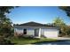 Charming single-story home with a well-manicured lawn and attached two-car garage at 14037 Canada Goose Rd, Brooksville, FL 34614