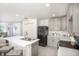 Well-lit kitchen features white countertops, gray cabinets, stainless steel appliances, and ample storage space at 14037 Canada Goose Rd, Brooksville, FL 34614