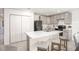 Stylish kitchen with gray cabinets, a center island with seating, and stainless steel appliances at 14037 Canada Goose Rd, Brooksville, FL 34614