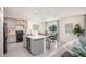 Modern kitchen features stainless steel appliances, a center island, and a view to the dining area at 14037 Canada Goose Rd, Brooksville, FL 34614