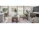 Bright living room features a comfortable sofa, stylish decor, and large windows that provide plenty of natural light at 14037 Canada Goose Rd, Brooksville, FL 34614