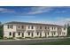 Charming townhome showcases a welcoming exterior with a well-manicured lawn and multiple front doors at 14052 Textile Run, Parrish, FL 34219