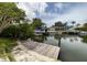 Waterfront property featuring a private dock with boat lifts and canal access at 568 Venice Ln, Sarasota, FL 34242
