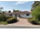 Charming single-story home with a beautiful red tile roof and circular brick driveway at 568 Venice Ln, Sarasota, FL 34242