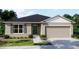 Charming single-story home with a well-manicured lawn and a two-car garage at 12368 Piping Plover Ave, Weeki Wachee, FL 34614