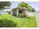 Expansive backyard with well-maintained lawn, screened patio, and privacy fence, ideal for outdoor living at 2647 Running Oak Ct, North Port, FL 34289