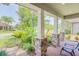 Charming front porch with brick accents and stone pillars, showcasing lush landscaping and neighborhood views at 2647 Running Oak Ct, North Port, FL 34289