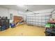 Garage with a roll-up door, painted floor, and storage cabinets at 2647 Running Oak Ct, North Port, FL 34289