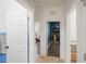 Hallway view showcasing multiple doorways with white doors and tile flooring at 2647 Running Oak Ct, North Port, FL 34289