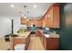 Spacious kitchen featuring granite countertops, wood cabinets, stainless steel appliances, and island seating at 2647 Running Oak Ct, North Port, FL 34289