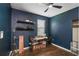Office space with dark blue walls, a ceiling fan, and natural light from a window at 2647 Running Oak Ct, North Port, FL 34289