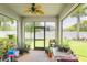 Enclosed screened patio featuring ample plants, a ceiling fan, and views of the lush backyard at 2647 Running Oak Ct, North Port, FL 34289
