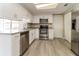 Modern kitchen with stainless steel appliances, granite countertops, and updated cabinets at 8744 Candlewick Ln, Port Richey, FL 34668