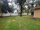 A spacious backyard featuring lush lawn, a privacy fence, and mature shade trees at 131 49Th E Ct, Palmetto, FL 34221