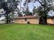 Back exterior view featuring green lawn, and mature trees at 131 49Th E Ct, Palmetto, FL 34221