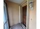 Close-up of front door with glass panels and an outdoor light fixture at 131 49Th E Ct, Palmetto, FL 34221