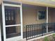 Covered and screened front entry with nice wooden front door at 131 49Th E Ct, Palmetto, FL 34221