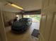 Attached garage with a parked car, providing convenient access to the home at 131 49Th E Ct, Palmetto, FL 34221