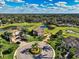Expansive aerial view showcasing a well-maintained property with water views and a golf course at 7315 Bianco Duck Ct, Sarasota, FL 34240